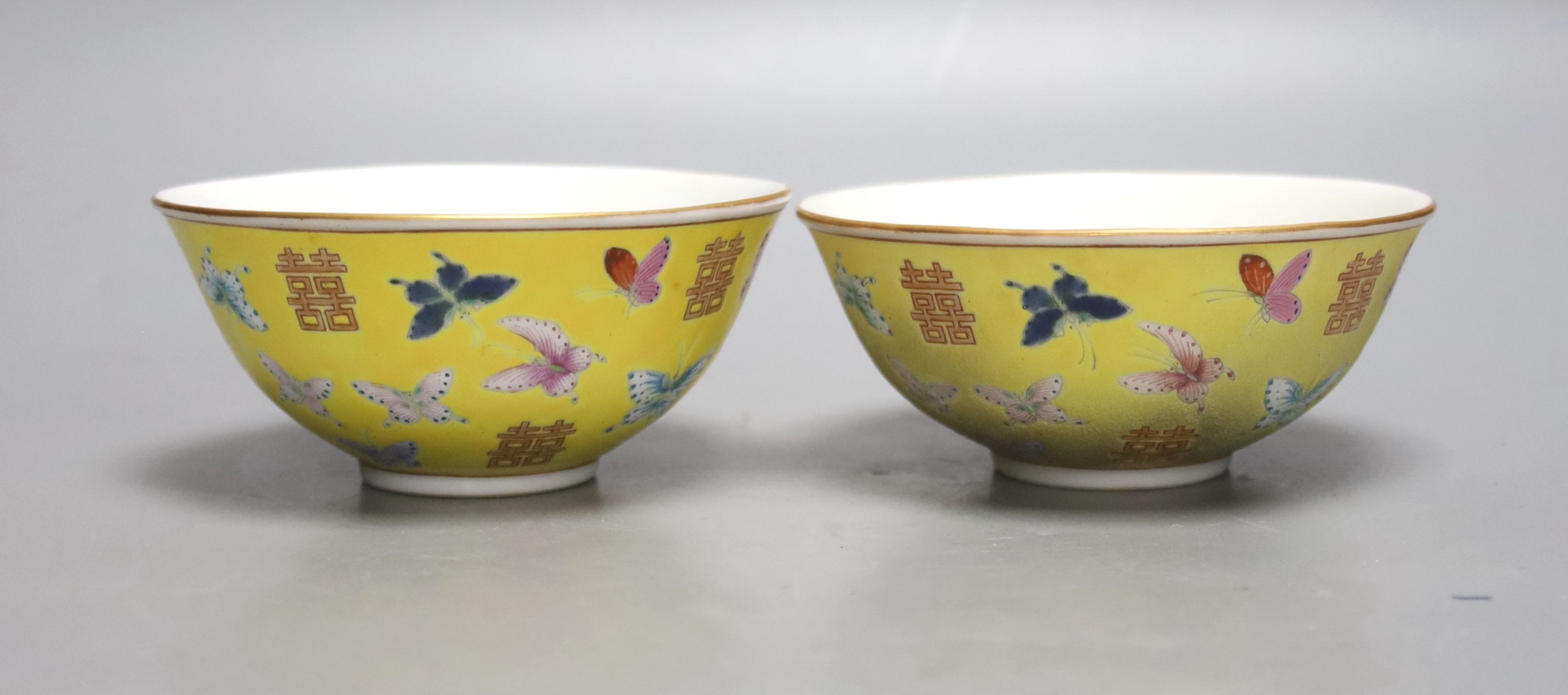 A pair of Chinese yellow ground porcelain small bowls, enamelled with butterflies, diameter 11cm